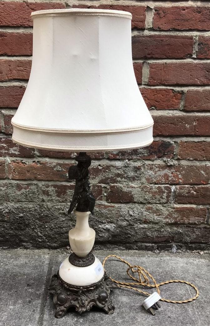 A brass and marble table lamp, the support decorated with a putti, raised on scrolled, squared base,