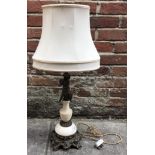 A brass and marble table lamp, the support decorated with a putti, raised on scrolled, squared base,