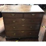 A mid-18th century walnut veneered chest of two short and three long graduated drawers, with cross-