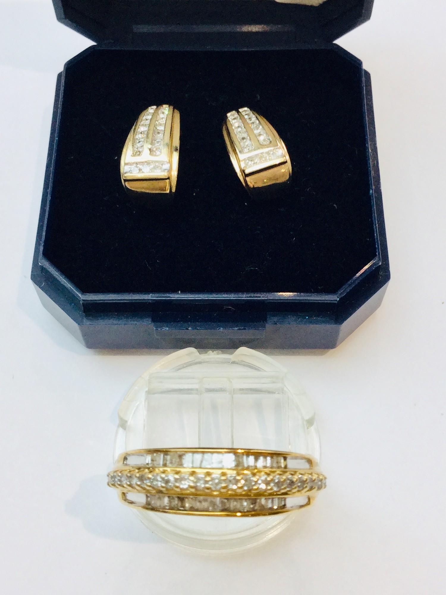 A 9ct gold dress ring set with baguette and round brilliant cut diamonds in a channel and claw