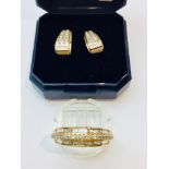 A 9ct gold dress ring set with baguette and round brilliant cut diamonds in a channel and claw