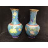 A pair of large Oriental cloisonné vases, with floral sprays to powder blue ground, central orange