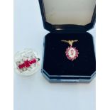 A ladys 9ct yellow gold ruby and diamond dress ring, set with 3 x baguette cut rubies to the