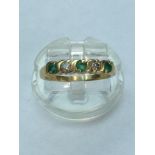 A lady's 18ct yellow gold Emerald & Diamond ring. Set with three round cut emeralds and two round