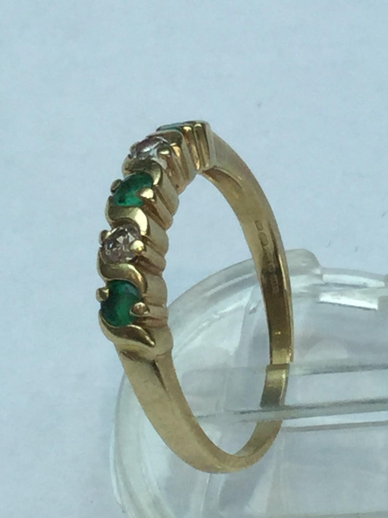 A lady's 18ct yellow gold Emerald & Diamond ring. Set with three round cut emeralds and two round - Image 3 of 3