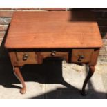 An 18th century walnut lowboy with herringbone inlay, three frieze drawers with brass ring pulls,