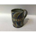 Charles Vyse (1882-1971) A stoneware mug with brown and blue decoration and reading 'Down The