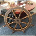 A 19th century eight-spoke wooden ship's wheel, with iron barrel plates and felloe ring, (with
