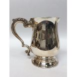 A Silver Christening Tankard, of oval bellied form, raised on circular spreading foot with