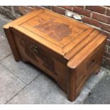 A large Chinese ornately carved camphor lined wood trunk, with scenes of ships and buildings, pro