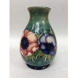A Moorcroft Pottery Vase of ovoid form with flared rim, decorated in the Pansies pattern to a