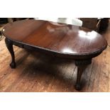 A Late Victorian stained and carved mahogany extending oval dining table, with extra leaf, lunette-
