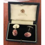 A pair of silver and red enamel gent's cufflinks, of oval shaped with chequered red enamel design,