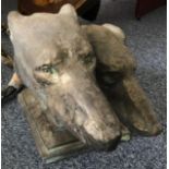 A 'bronzed' and patinated ceramic sculpture of two racing Greyhound heads, on integral plinth,