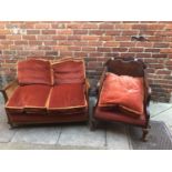 An Edwardian Bergere two-seater sofa with dark orange upholstered cushions and a similar chair, with
