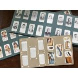 A collection of assorted cigarette cards across three albums including football and snooker cards