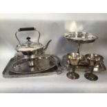 A quantity of silver-plated items including two trays, spirit kettle, tureen and cover, bonbon