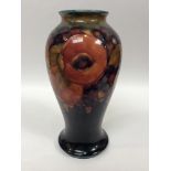 A Moorcroft Pottery vase of inverted baluster form decorated with the Pomegranate pattern to a