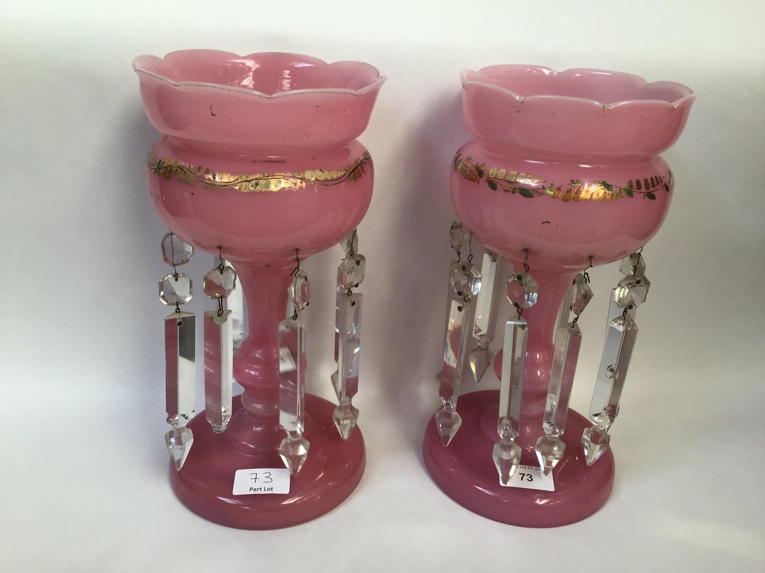 A pair of Victorian pink lustres with scalloped edges, decorated with gilt highlights and hung