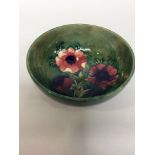 A Moorcroft Pottery bowl, decorated in the Pansies pattern to a green/blue ground, impressed mark to