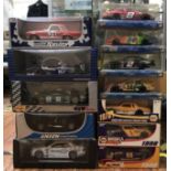 12 various boxed die cast model racing cars of scale 1:18 (5) & 1:24 (7).