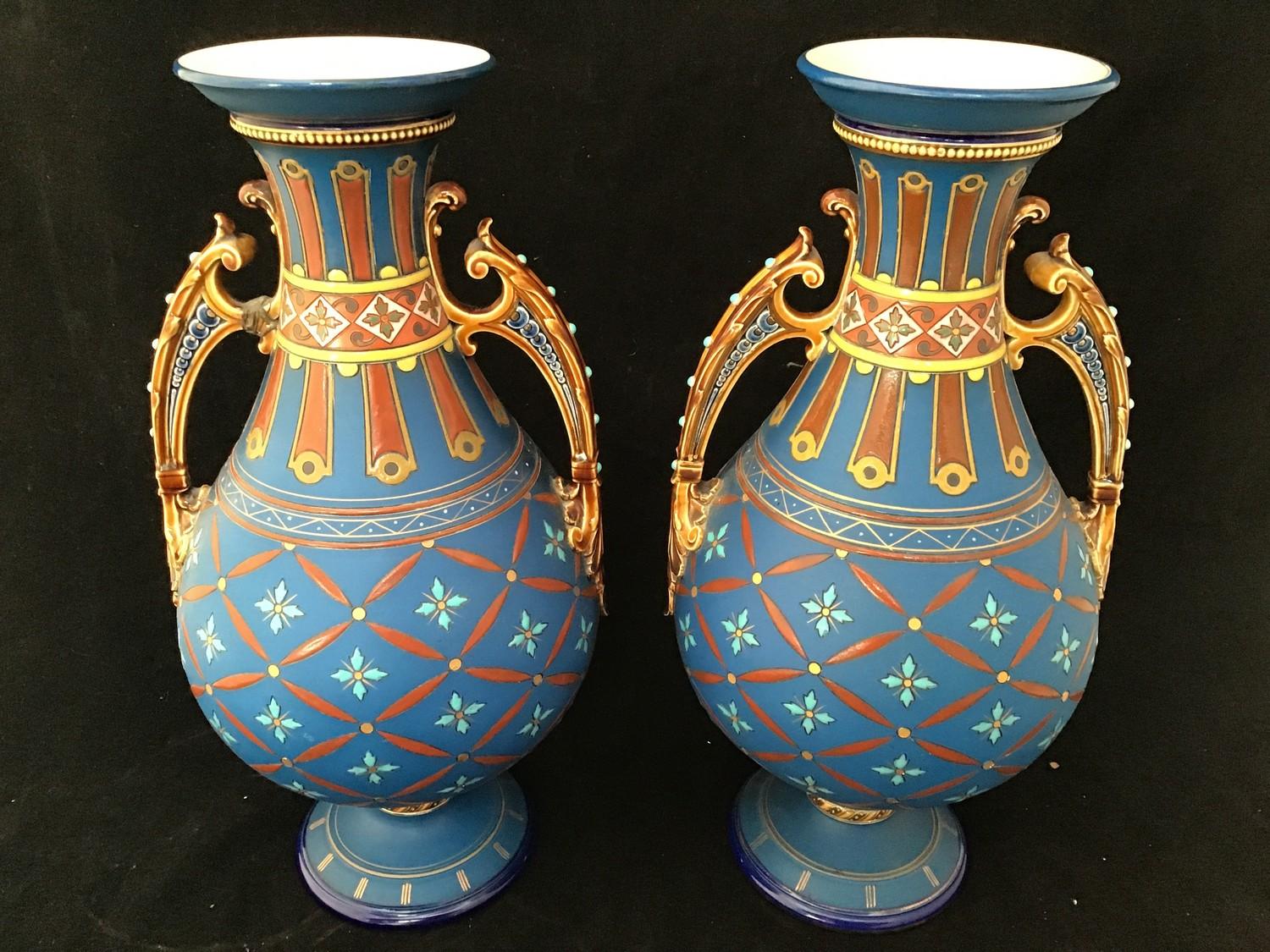 A pair of Mettlach twin-handled vases, of baluster form with beaded necks, ornate scrolled brown