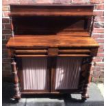 A Victorian Rosewood chiffonier, with raised shelved back, a pair of pulvinated drawers above a pair