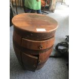 An antique coopered oak barrel converted to a cupboard/table with a single drawer above a pair of