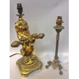 A gilt composition table lamp modelled as a Heraldic seated lion, 38cm high, together with a brass