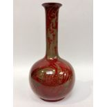 A Bernard Moore Art Pottery vase of shaft and globe form decorated with flambe glazes of stylised