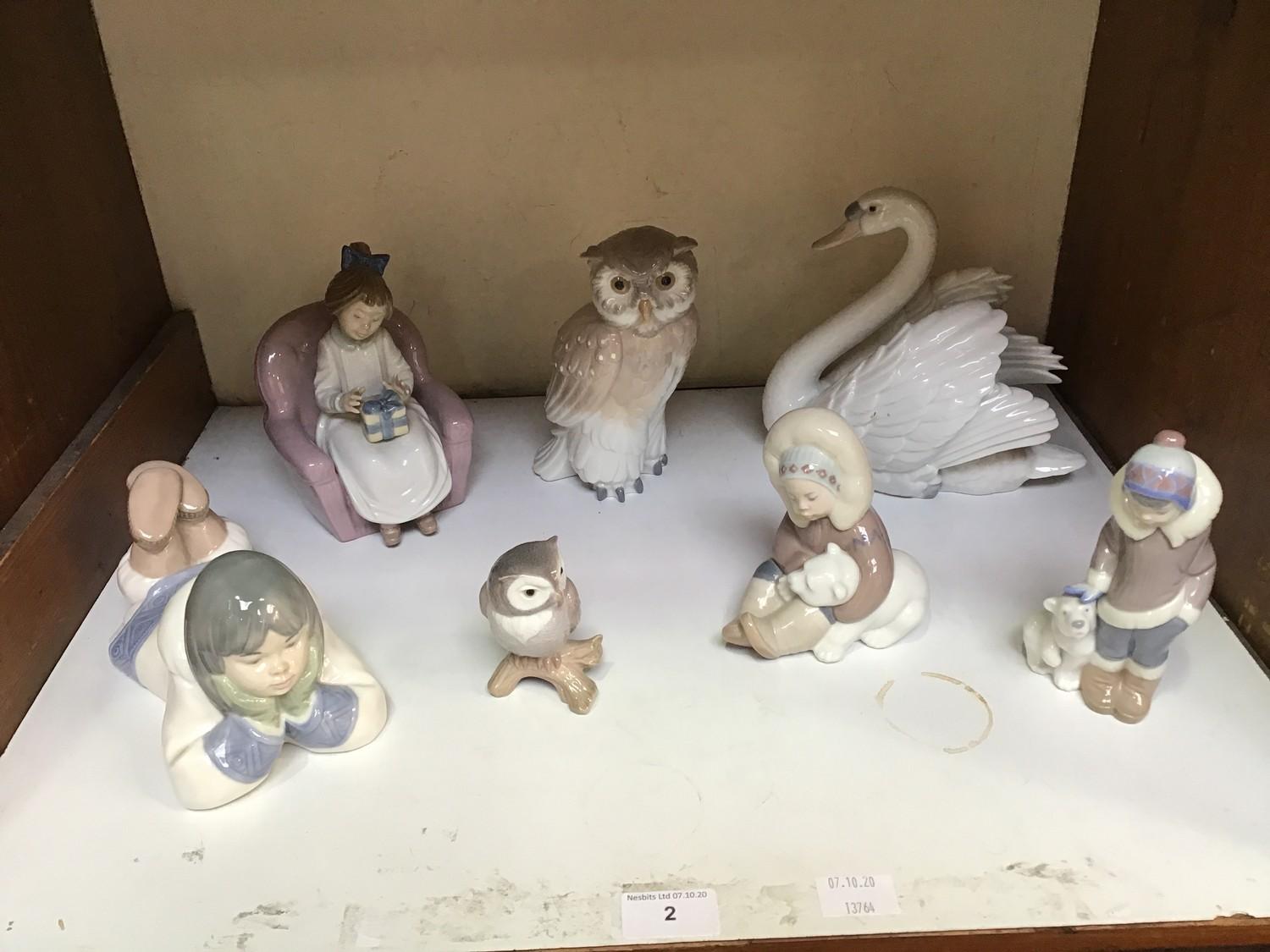 SECTION 20. Four assorted Lladro figures including A swan '5231', 'Eskimo with Polar Bear Cub