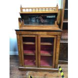 An Edwardian inlaid walnut two-door glazed pier cabinet enclosing two shelves, with raised galleried