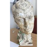 A 20th century cast plaster sculpture of a male head, (af), 35m