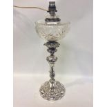 An Elkington & Co electroplated oil lamp in the Rococo style, with cut glass reservoir, converted to