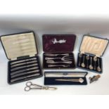 A boxed Y2K silver letter opener and cased set of butter knives with silver handles, together with