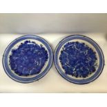 A pair of 20th century Portuguese pottery chargers, painted with blue flowers and foliage, 36cm