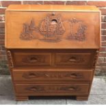 A Chinese ornately carved wooden bureau with fall front opening to reveal drawer and