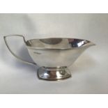 A silver sauce boat with angular mid section, shaped handle, hallmarked Sheffield, 1938, maker's