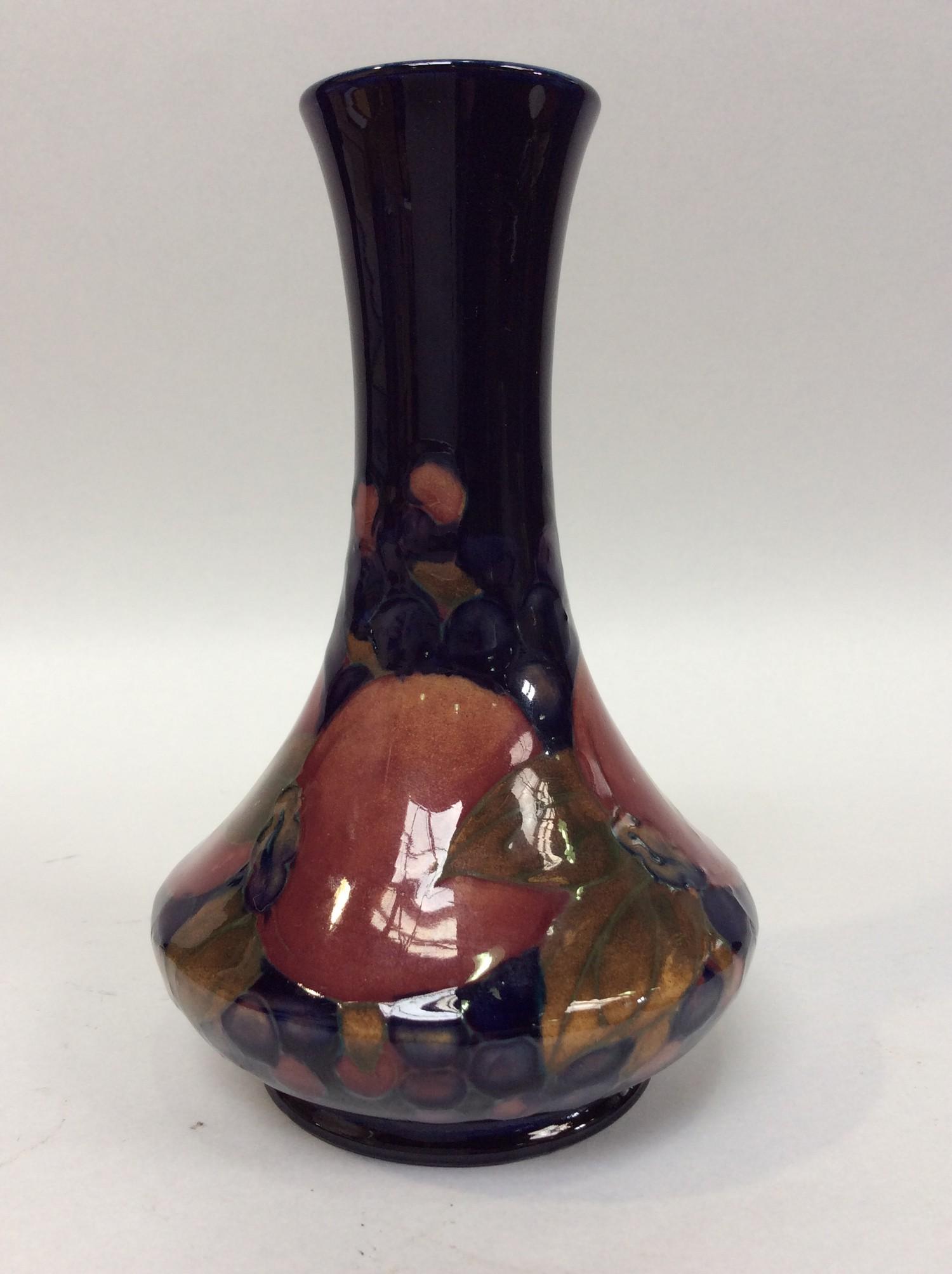 A Moorcroft pottery vase of Persian form with slender neck and compressed globular body, decorated