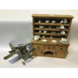 A miniature pine dresser with four open shelves with hanging hooks, above three short drawers, a