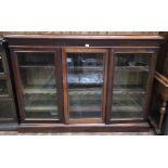 An early to mid 19th century mahogany standing bookcase, with three glazed doors enclosing