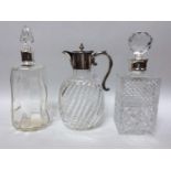 A Victorian glass claret jug with spiral reeded oval body, silver-plated handle and lidded spout,