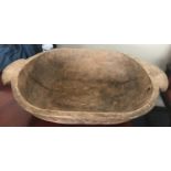 A continental chip-carved elm oval wooden dough bowl, 67cm x 47cm (natural shrinkage split with