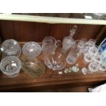 A shelf of assorted cut glass including eight Galway Crystal brandy balloons, large bowls, Sowerby