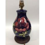 A Moorcroft Pottery table lamp, of ovoid form with flared rim, decorated in the Clematis pattern