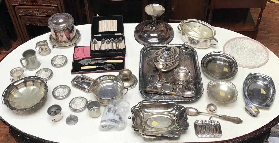 A large quantity of silver-plated items including trays, teapot, coffee cups, ice bucket, glass