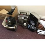 An assortment of mixed cameras and equipment including a Bell & Howell 8mm projector, a Bell &