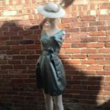 A sea green short dress by Catherine Regehr, size P, a cream hat with green ribbon, floral lace