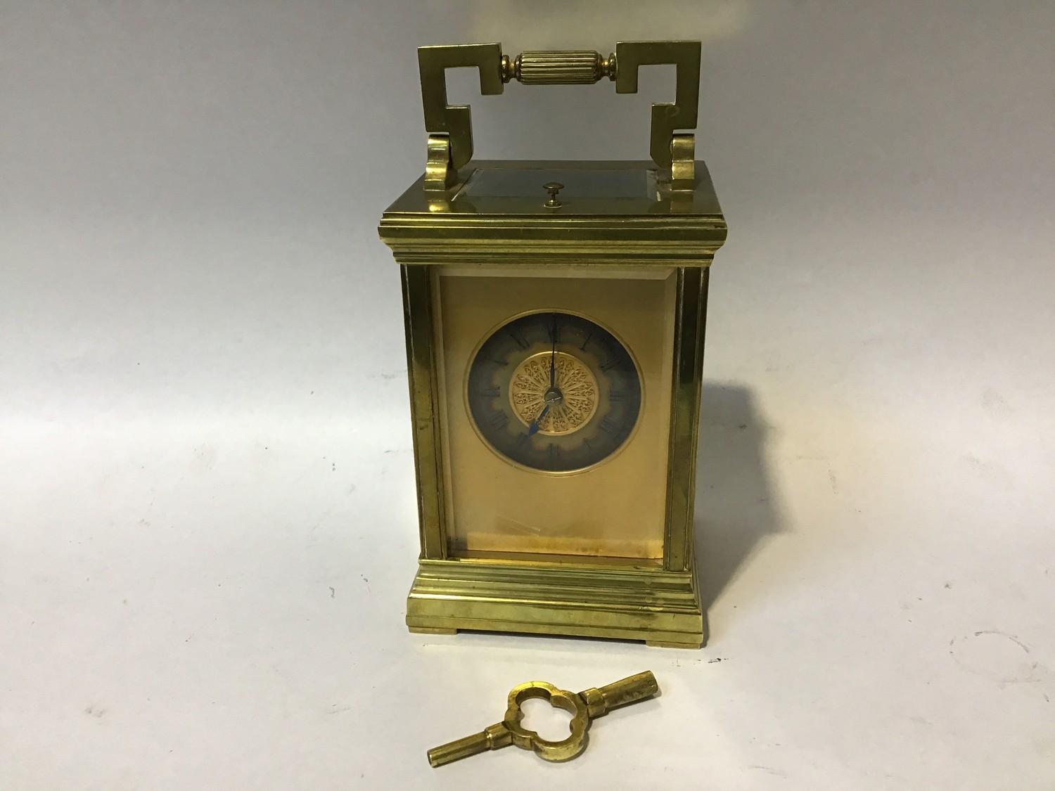 A gilt-brass repeater carriage clock, the gilt dial with Roman numerals denoting hours and