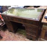 A Victorian mahogany kneehole twin pedestal desk, with green leather gilt tooled scribe and